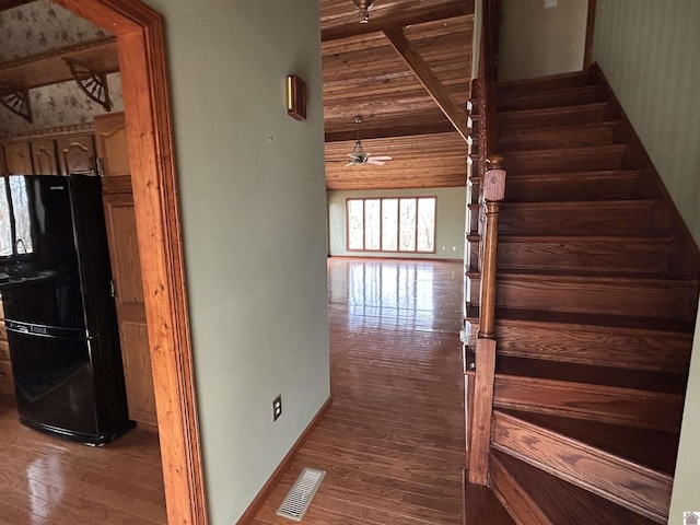 hall featuring visible vents, stairway, wood finished floors, wooden ceiling, and baseboards