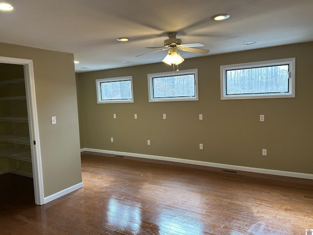 spare room with recessed lighting, plenty of natural light, and baseboards