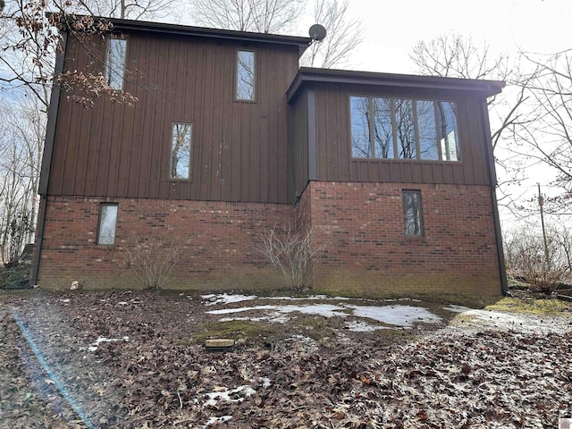 view of side of home with brick siding