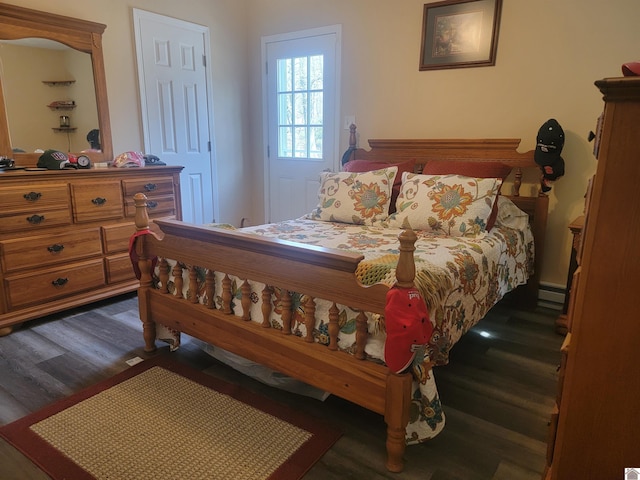 bedroom with a baseboard radiator and dark wood-type flooring