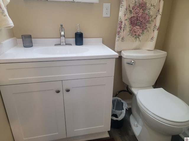 bathroom featuring toilet and vanity