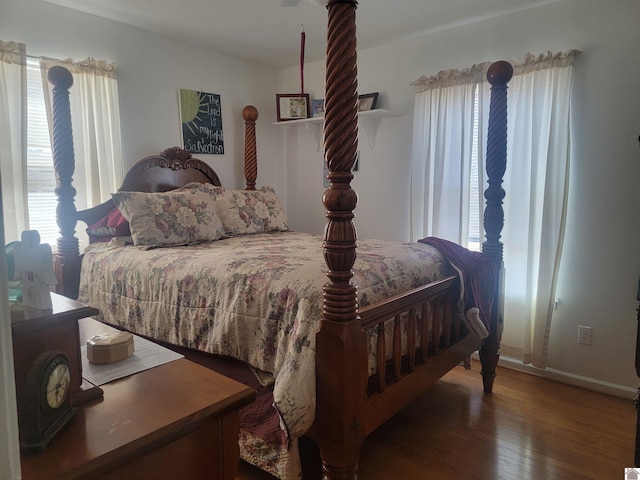 bedroom with dark wood-style floors