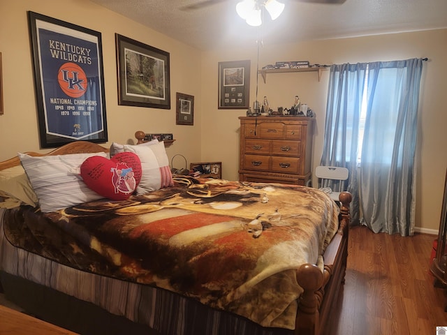 bedroom featuring dark wood-type flooring and a ceiling fan