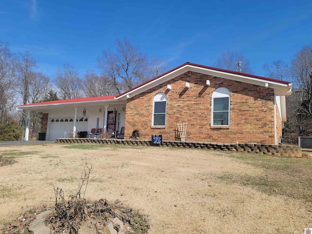 ranch-style home featuring driveway, a porch, an attached garage, and brick siding