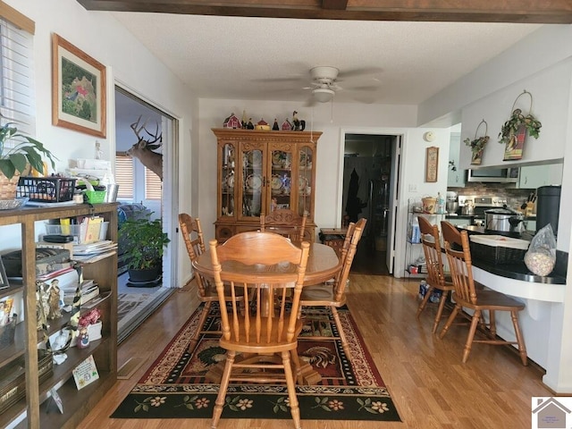 dining area with a ceiling fan and wood finished floors