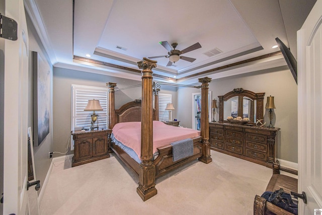 bedroom with light carpet, visible vents, a raised ceiling, and crown molding