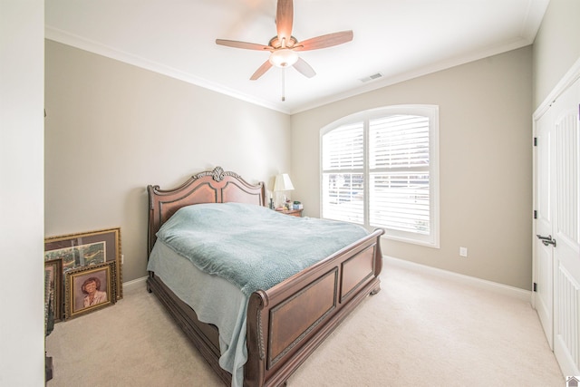 bedroom featuring crown molding, baseboards, visible vents, and light colored carpet