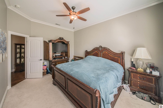 bedroom with ceiling fan, light carpet, visible vents, baseboards, and crown molding