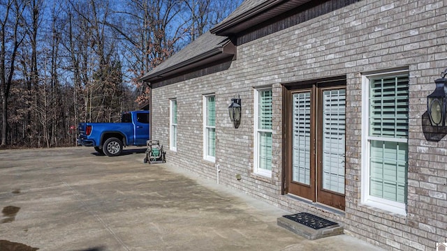 view of side of property with brick siding