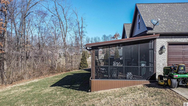 view of home's exterior featuring a yard, brick siding, roof with shingles, and a sunroom