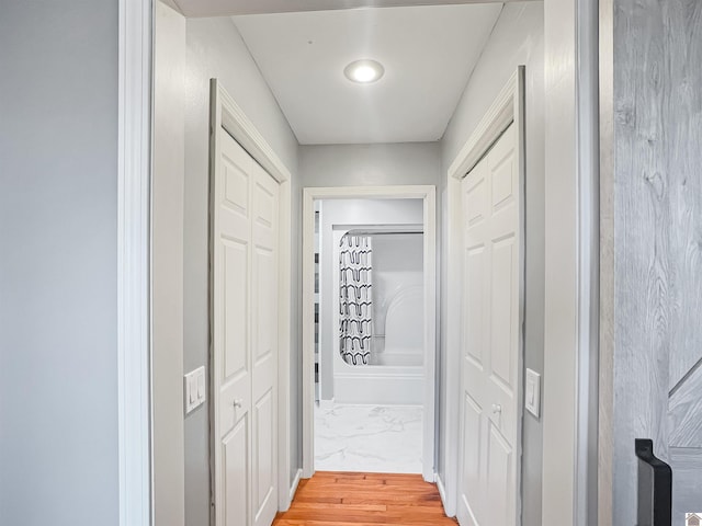 hall featuring marble finish floor