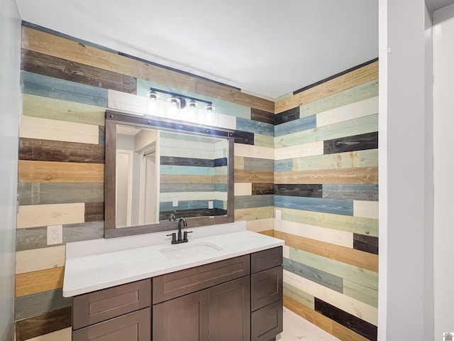 bathroom featuring wood walls and vanity