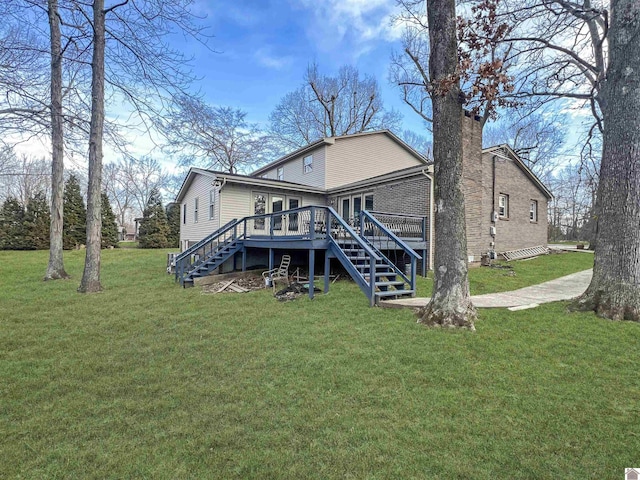 back of house with a chimney, stairway, a deck, a yard, and brick siding