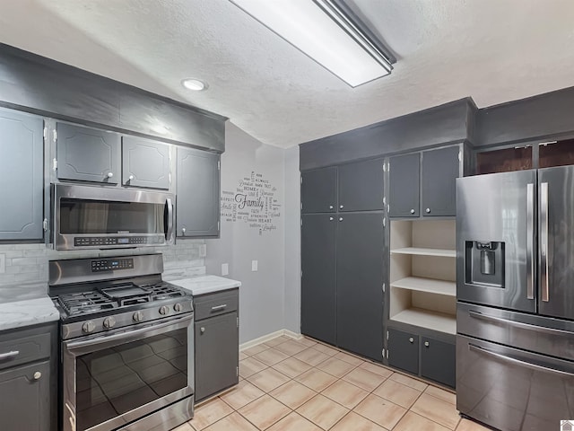 kitchen featuring open shelves, appliances with stainless steel finishes, light countertops, and decorative backsplash