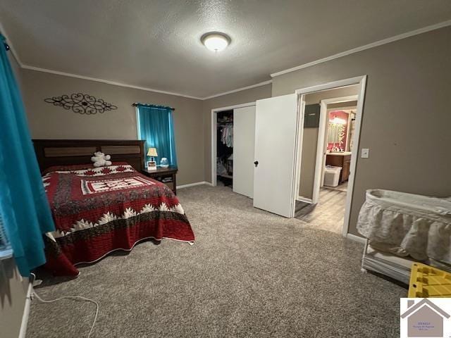 bedroom with baseboards, a closet, carpet flooring, and crown molding