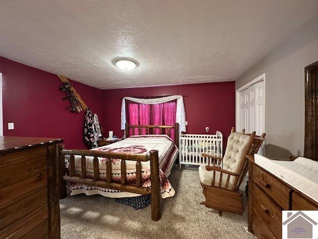 carpeted bedroom featuring a textured ceiling