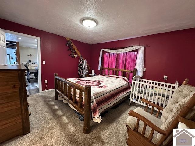 bedroom with carpet and a textured ceiling