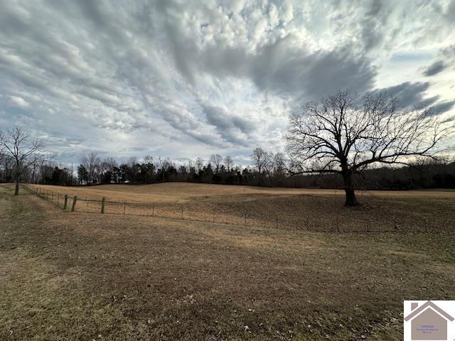 view of yard featuring fence and a rural view