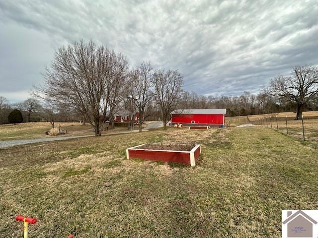 view of home's community featuring a rural view and a lawn