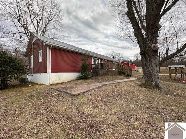 view of home's exterior with metal roof and a wooden deck