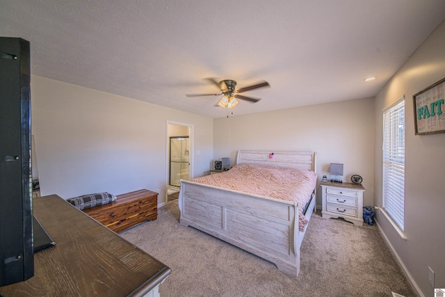 bedroom with carpet floors, ensuite bathroom, ceiling fan, a textured ceiling, and baseboards