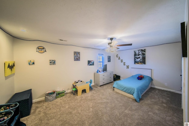 carpeted bedroom featuring visible vents, a ceiling fan, and baseboards