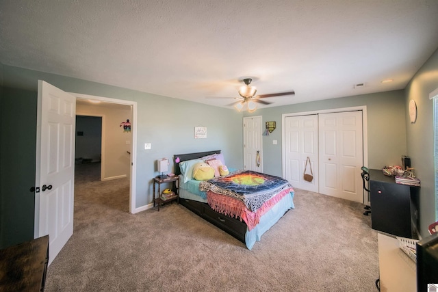 bedroom featuring ceiling fan, visible vents, baseboards, and carpet flooring