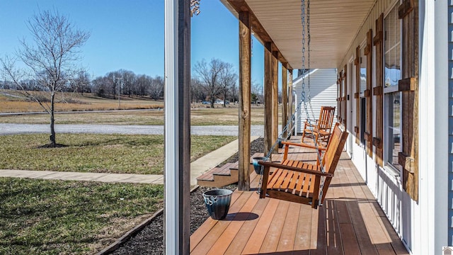 deck with covered porch and a yard