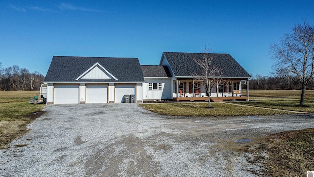 view of front of house featuring driveway, a porch, a front lawn, and roof with shingles