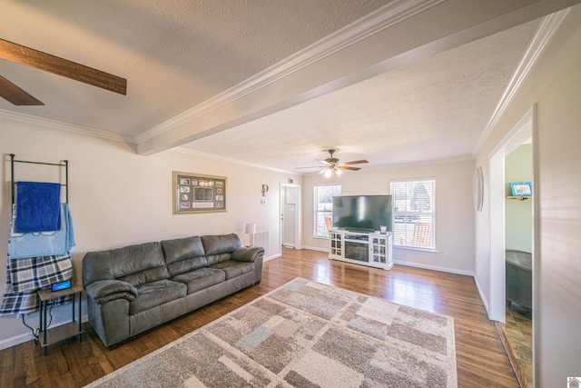 living room featuring a textured ceiling, wood finished floors, a ceiling fan, and crown molding