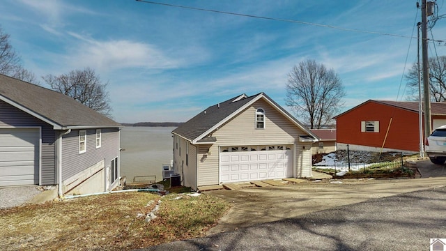 view of property exterior with a garage and an outdoor structure