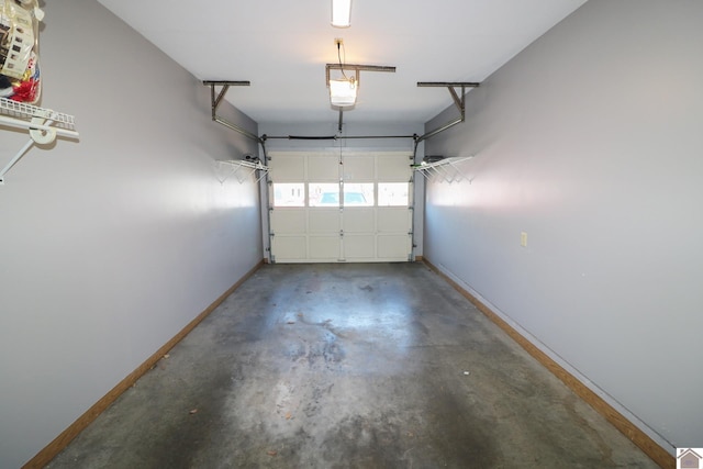 garage featuring a garage door opener and baseboards