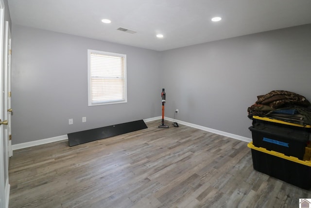 interior space featuring recessed lighting, visible vents, baseboards, and wood finished floors