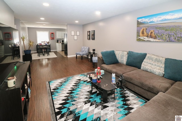 living area with recessed lighting, baseboards, and wood finished floors