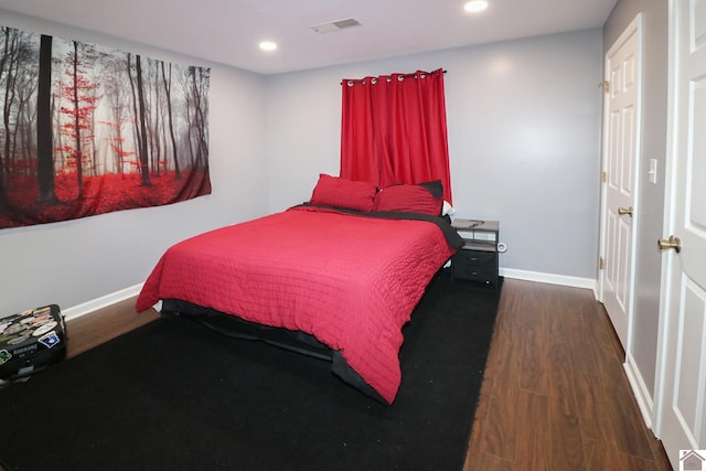 bedroom with recessed lighting, visible vents, baseboards, and wood finished floors