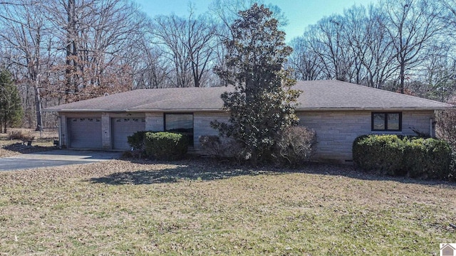 ranch-style home featuring an attached garage, a shingled roof, driveway, stone siding, and a front lawn