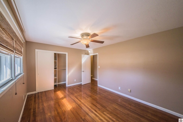 unfurnished bedroom featuring ceiling fan, a closet, wood finished floors, and baseboards