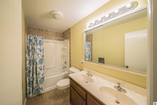 bathroom featuring double vanity, tile patterned flooring, a sink, and toilet