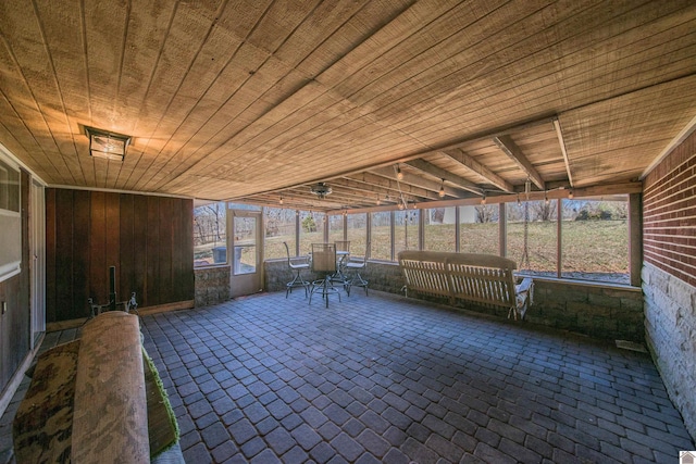 unfurnished sunroom featuring wooden ceiling and a wealth of natural light