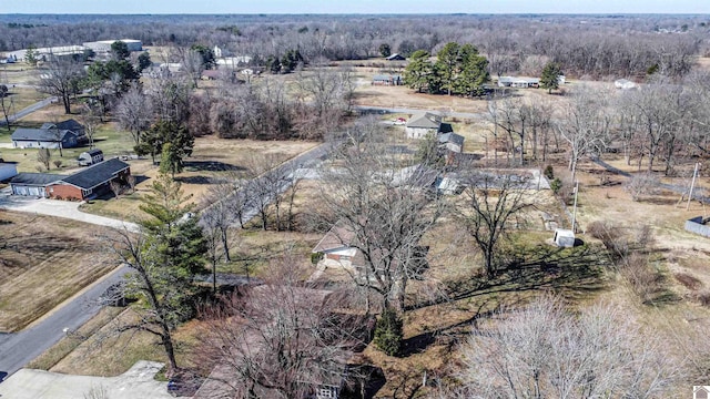 drone / aerial view featuring a wooded view