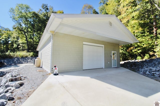 detached garage with concrete driveway