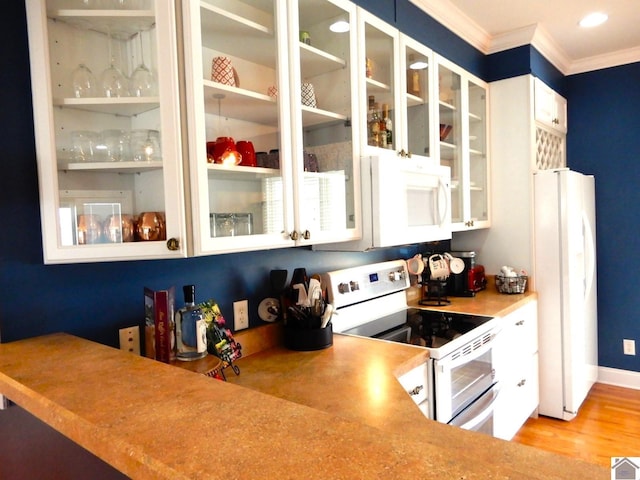 kitchen with light wood finished floors, ornamental molding, glass insert cabinets, white cabinetry, and white appliances