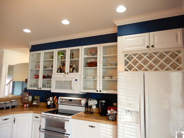 kitchen with light countertops, ornamental molding, glass insert cabinets, white cabinets, and white appliances