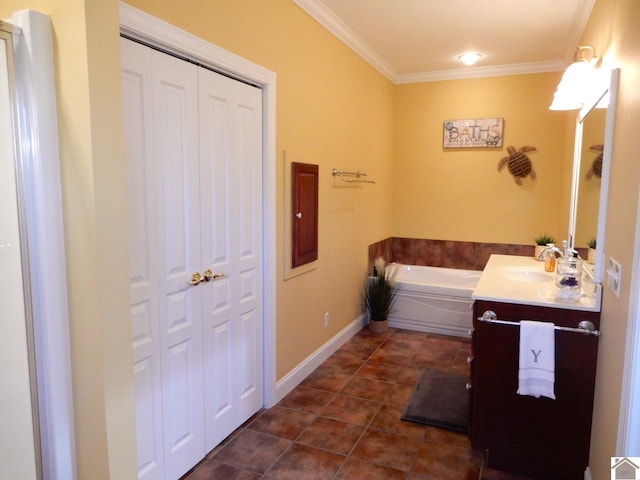 bathroom with crown molding, vanity, a bath, baseboards, and tile patterned floors