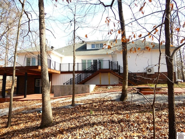 back of property with stairs, a patio, and a deck