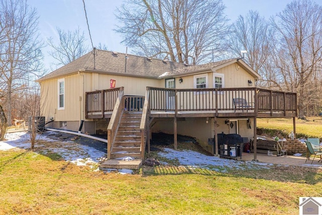 back of house featuring stairs, a yard, a shingled roof, and a wooden deck