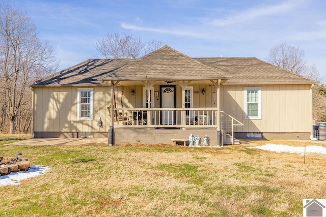 rear view of house with crawl space, covered porch, a lawn, and roof with shingles