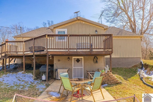 back of property featuring a patio area, a shingled roof, outdoor dining area, and a wooden deck