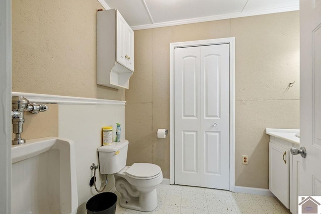 half bath with toilet, vanity, baseboards, ornamental molding, and tile patterned floors