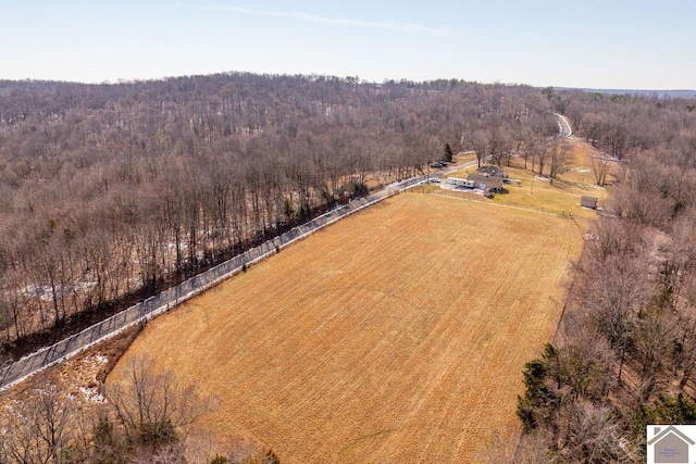 drone / aerial view featuring a wooded view